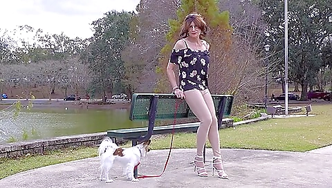Solo amateur brunette in a sexy outfit moves on a walk
